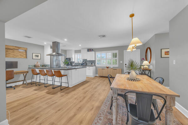 102 Pineview Road Jupiter, FL 33469 - Photo 7 of 34 a living room with stainless steel appliances kitchen island granite countertop furniture and a wooden floor