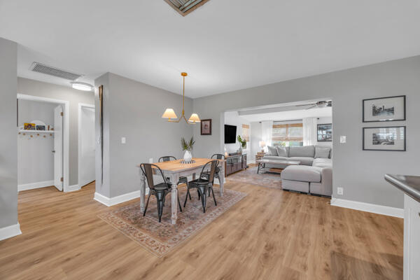 102 Pineview Road Jupiter, FL 33469 - Photo 8 of 34 a view of a dining room with furniture and wooden floor