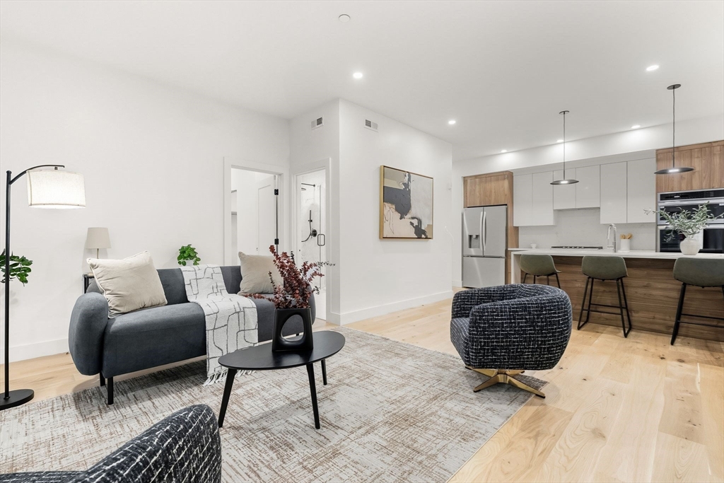 47 Condor Street, Unit 202 Boston, MA 02128 - Photo 2 of 17 a living room with furniture and wooden floor