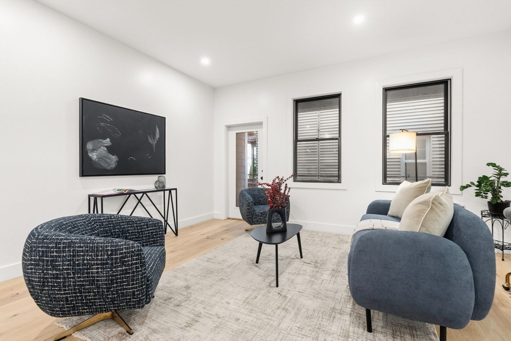 47 Condor Street, Unit 202 Boston, MA 02128 - Photo 7 of 17 a living room with furniture and a flat screen tv
