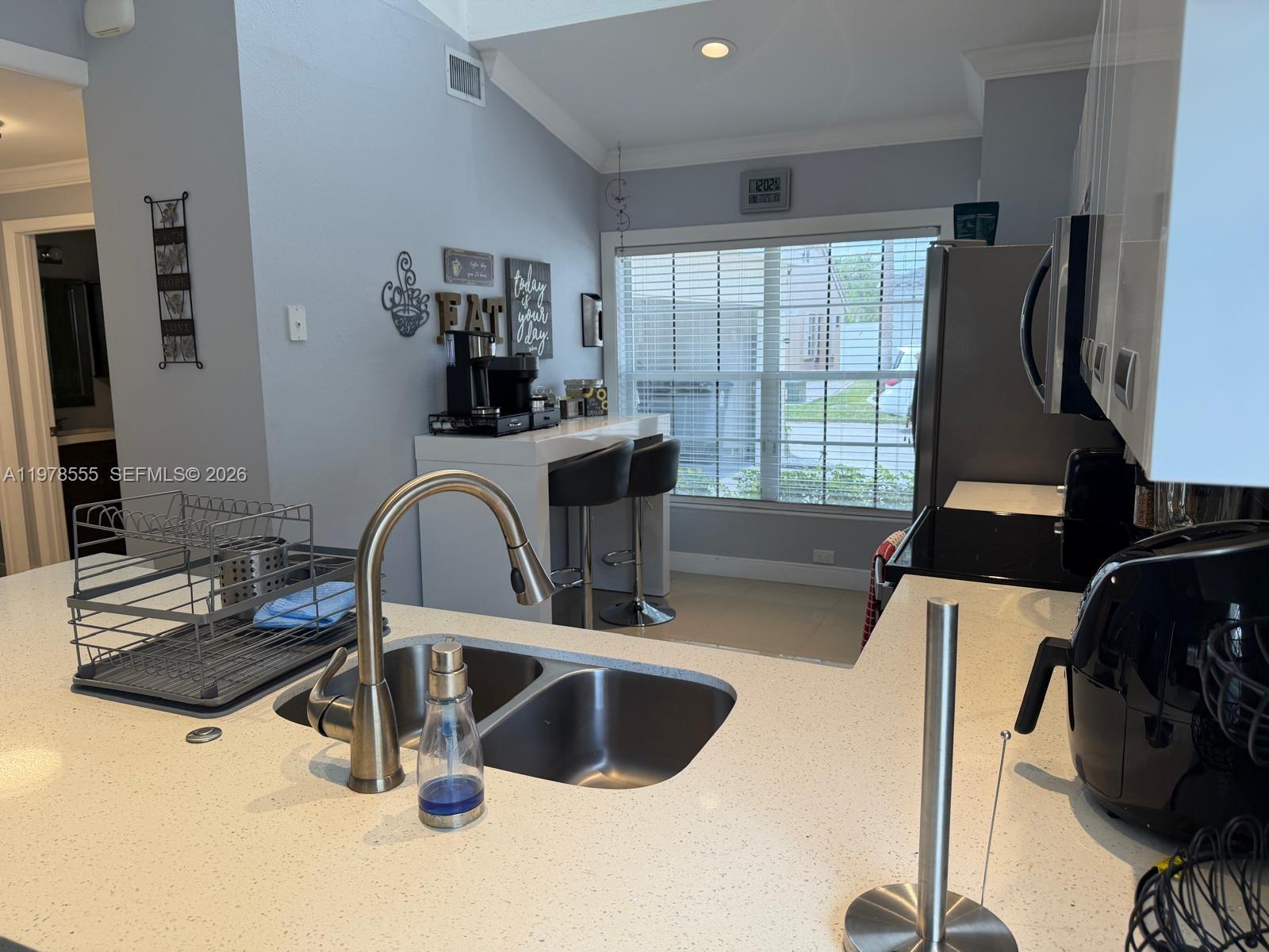 10285 Allegro Drive Boca Raton, FL 33428 - Photo 16 of 55 a kitchen with a faucet a sink and a refrigerator