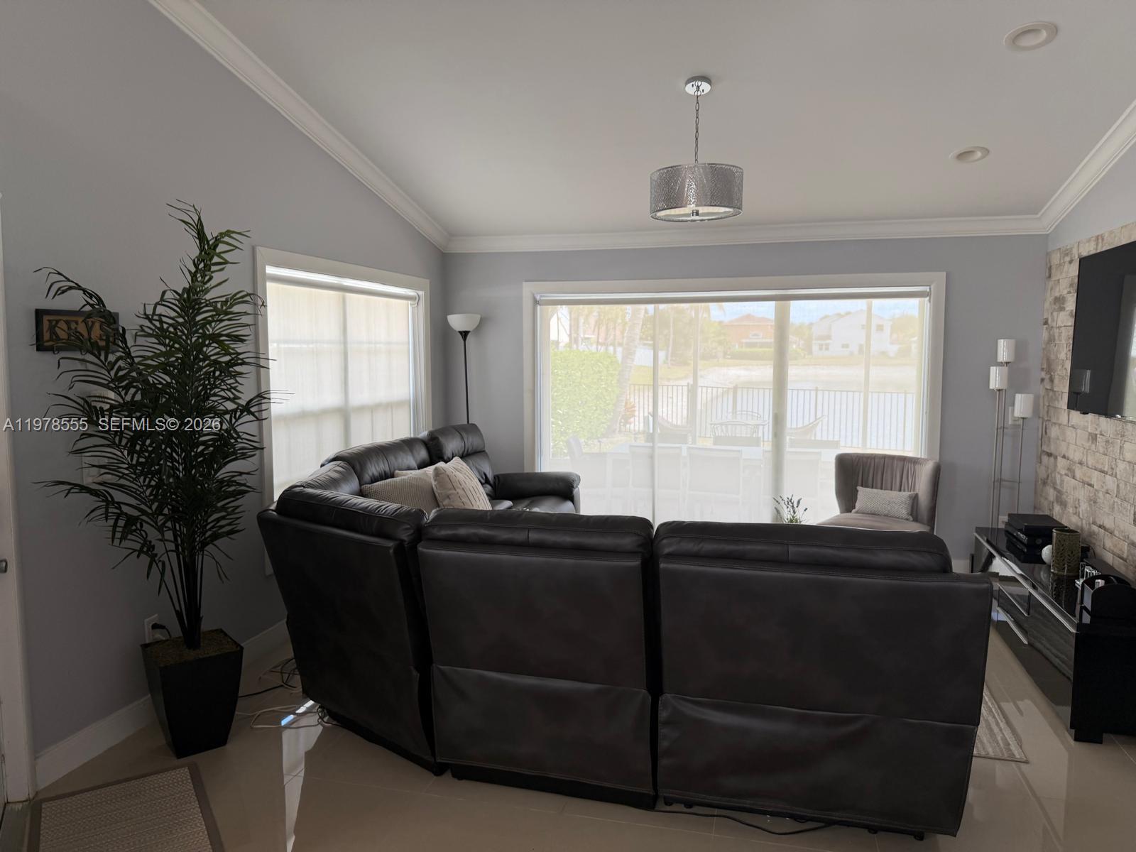 10285 Allegro Drive Boca Raton, FL 33428 - Photo 24 of 55 a room with a balcony a bed window and a television