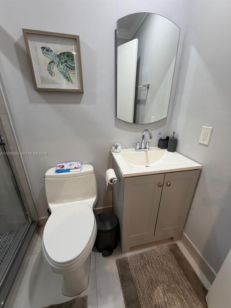 10285 Allegro Drive Boca Raton, FL 33428 - Photo 25 of 55 a bathroom with a toilet sink and mirror