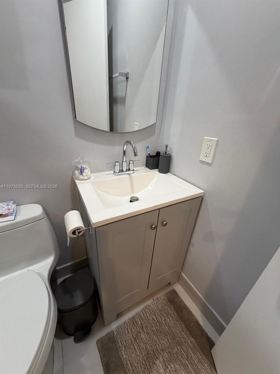 10285 Allegro Drive Boca Raton, FL 33428 - Photo 28 of 55 a bathroom with a sink and a toilet