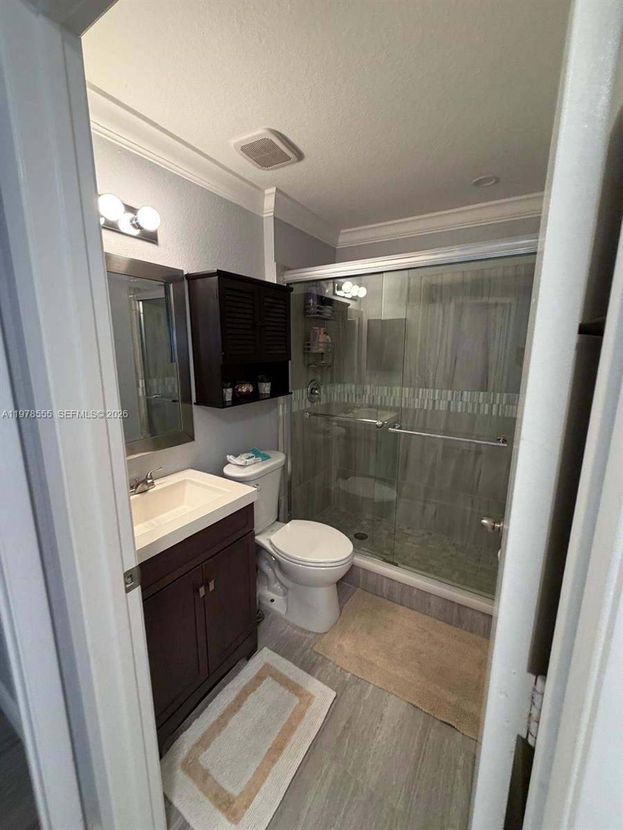 10285 Allegro Drive Boca Raton, FL 33428 - Photo 37 of 55 a bathroom with a toilet a sink and a shower