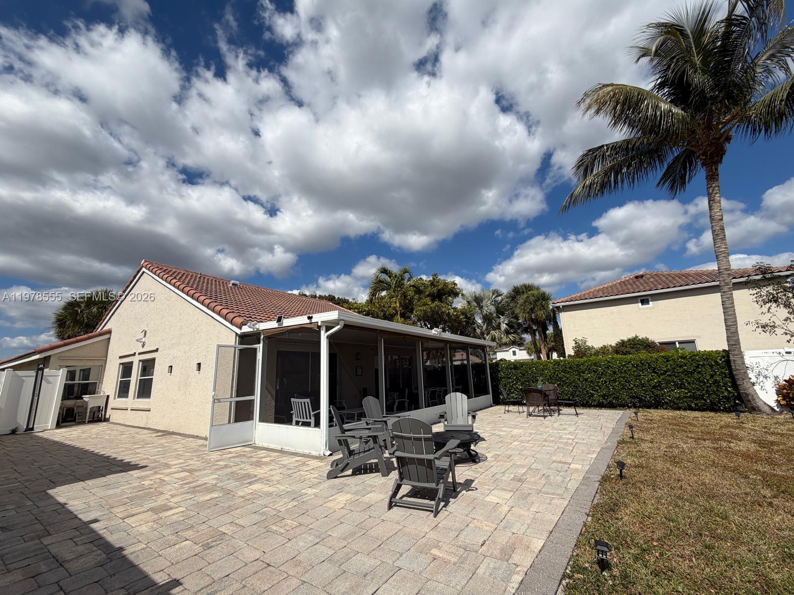 10285 Allegro Drive Boca Raton, FL 33428 - Photo 39 of 55 a view of a terrace with furniture and a yard