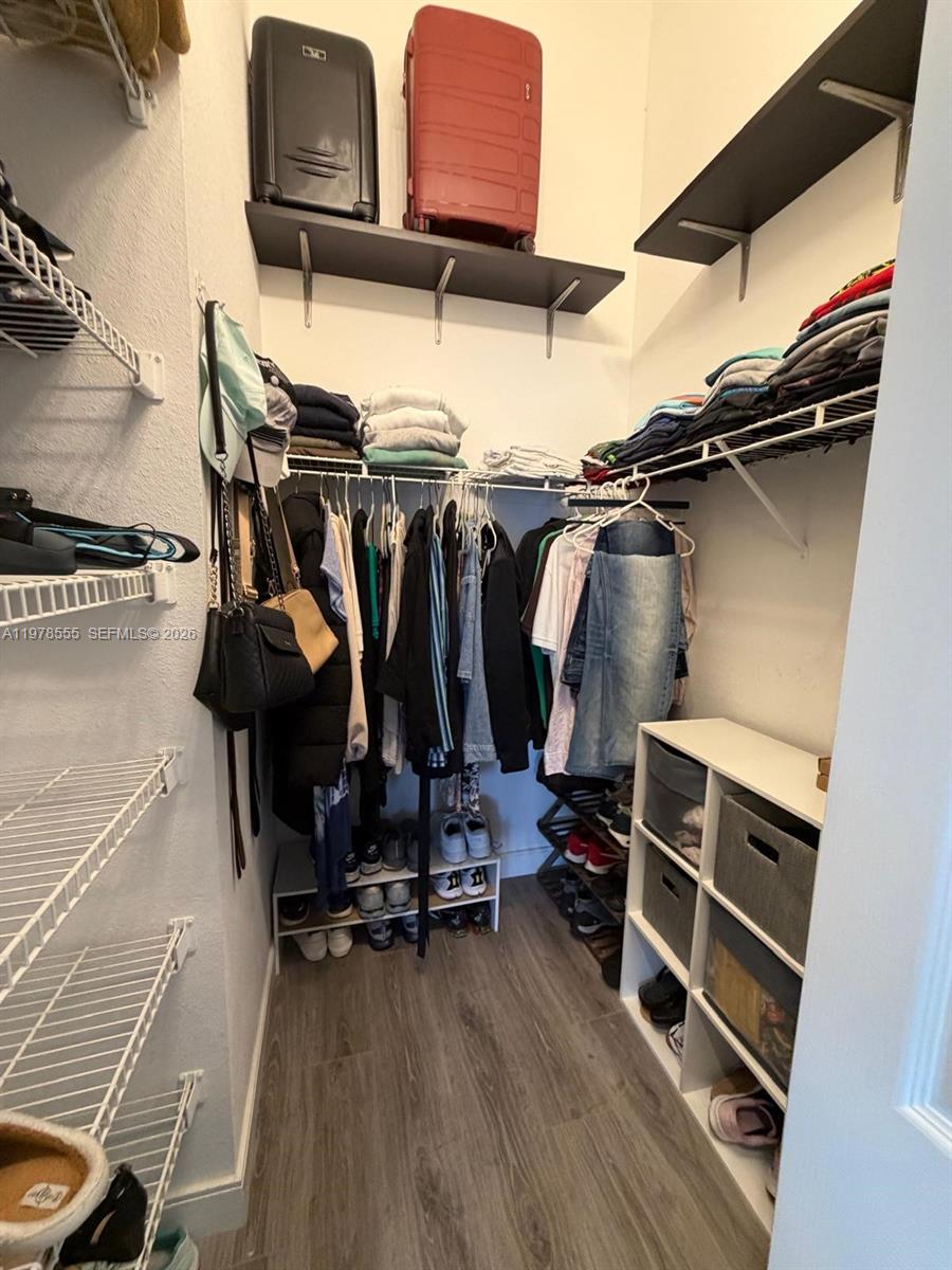 10285 Allegro Drive Boca Raton, FL 33428 - Photo 47 of 55 a view of walk in closet with clothes and shoes