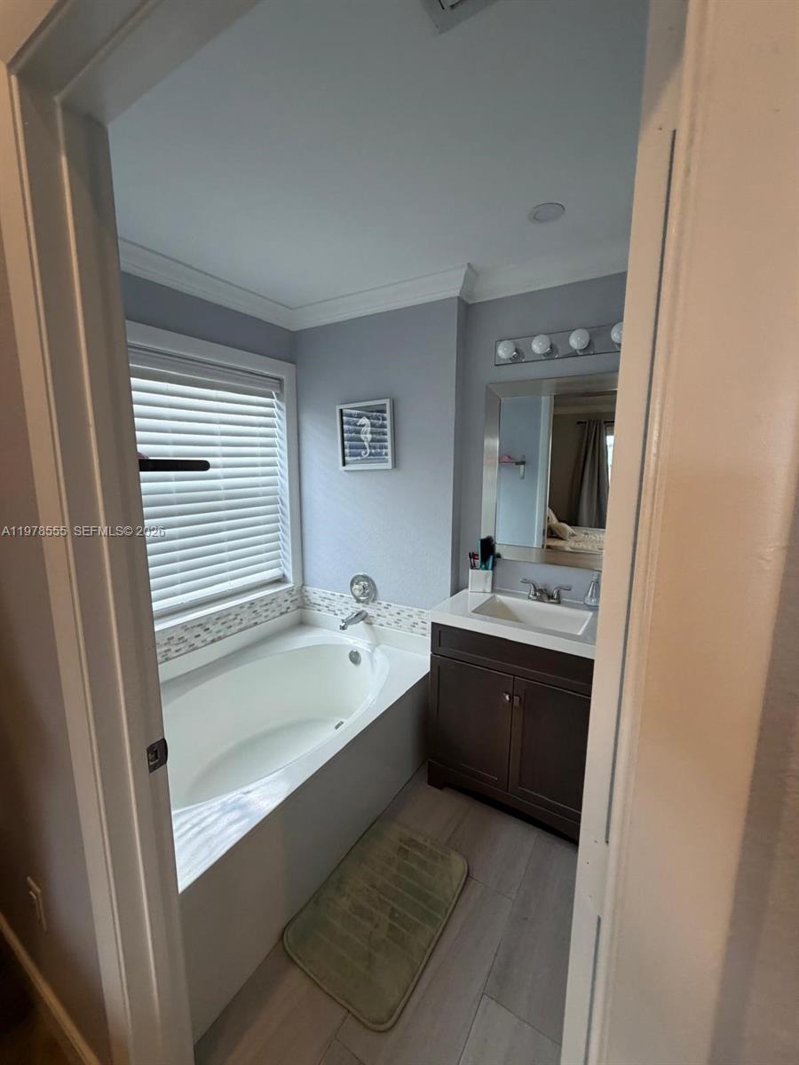 10285 Allegro Drive Boca Raton, FL 33428 - Photo 49 of 55 a bathroom with a tub sink and mirror