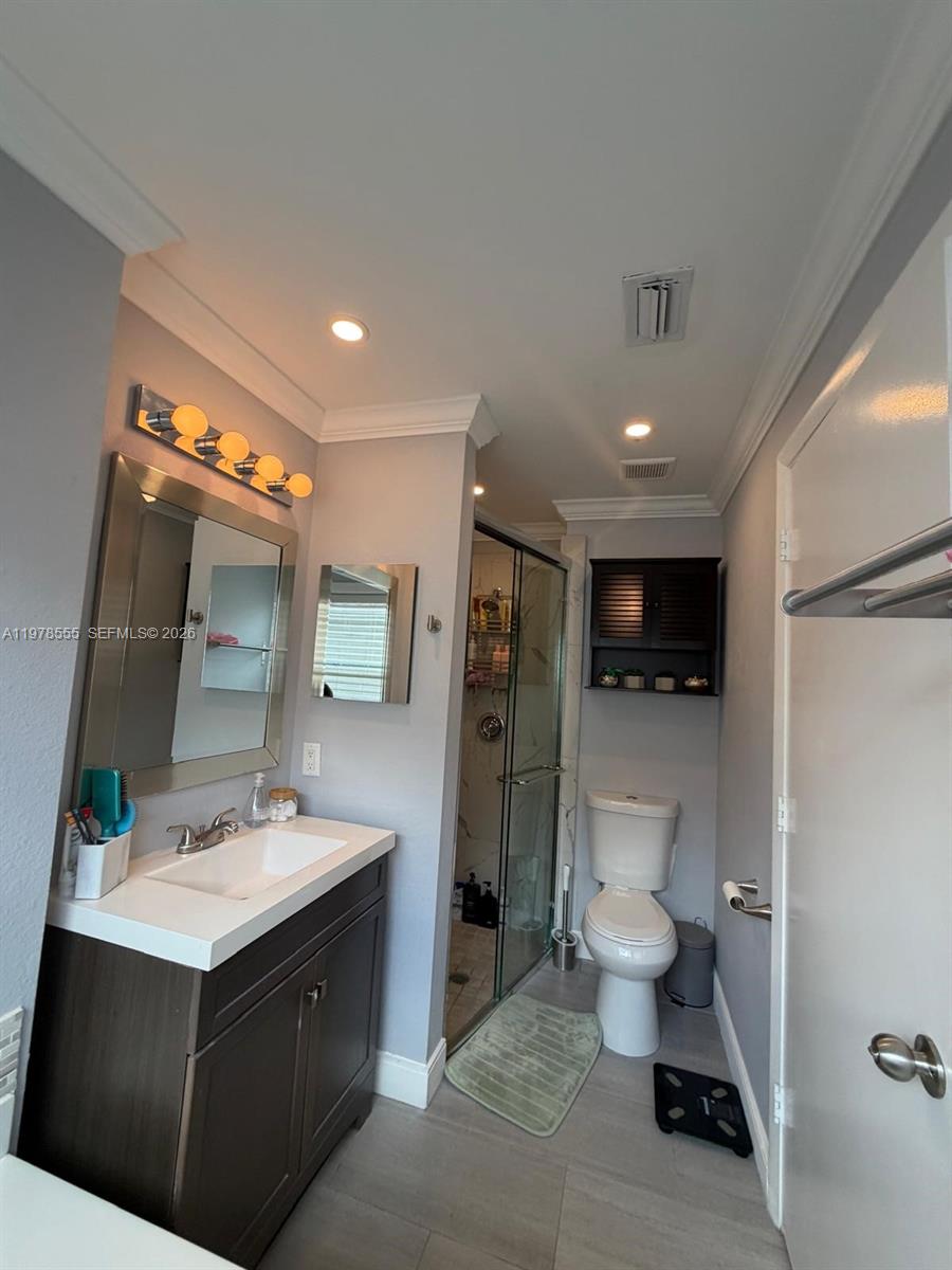 10285 Allegro Drive Boca Raton, FL 33428 - Photo 50 of 55 a bathroom with a sink vanity and a mirror