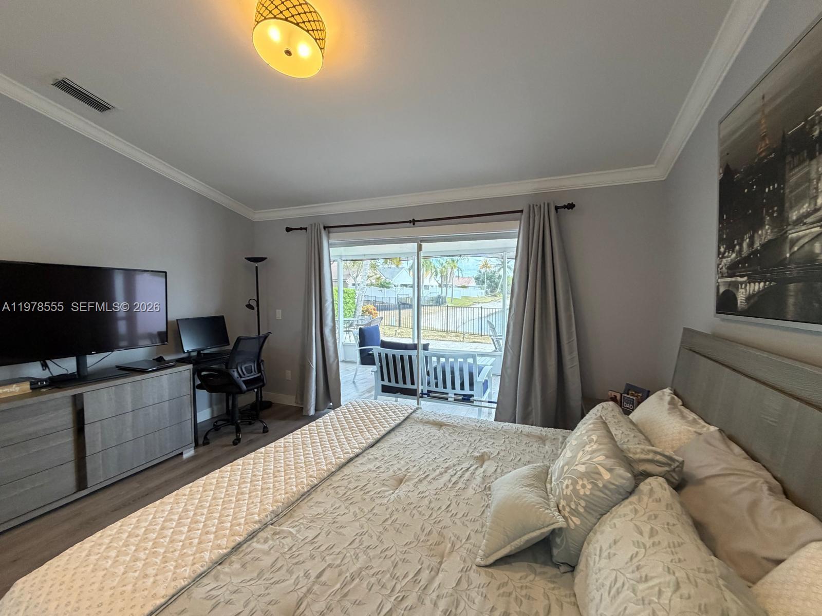 10285 Allegro Drive Boca Raton, FL 33428 - Photo 5 of 55 a bedroom with a bed and a tv on dresser