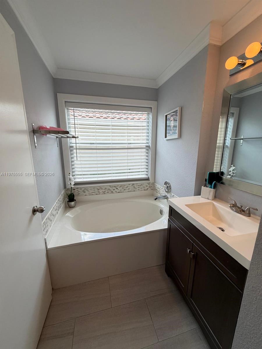 10285 Allegro Drive Boca Raton, FL 33428 - Photo 51 of 55 a bathroom with a bathtub and a sink