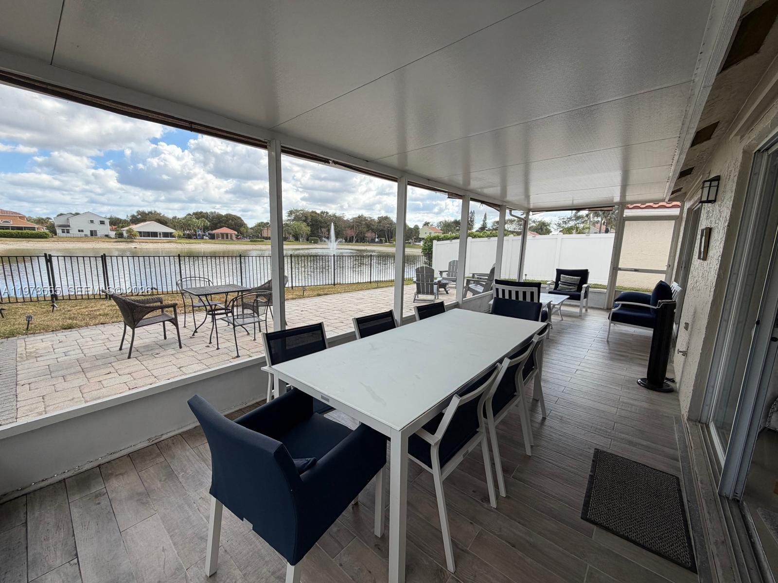 10285 Allegro Drive Boca Raton, FL 33428 - Photo 52 of 55 a view of a dining room with furniture window and wooden floor