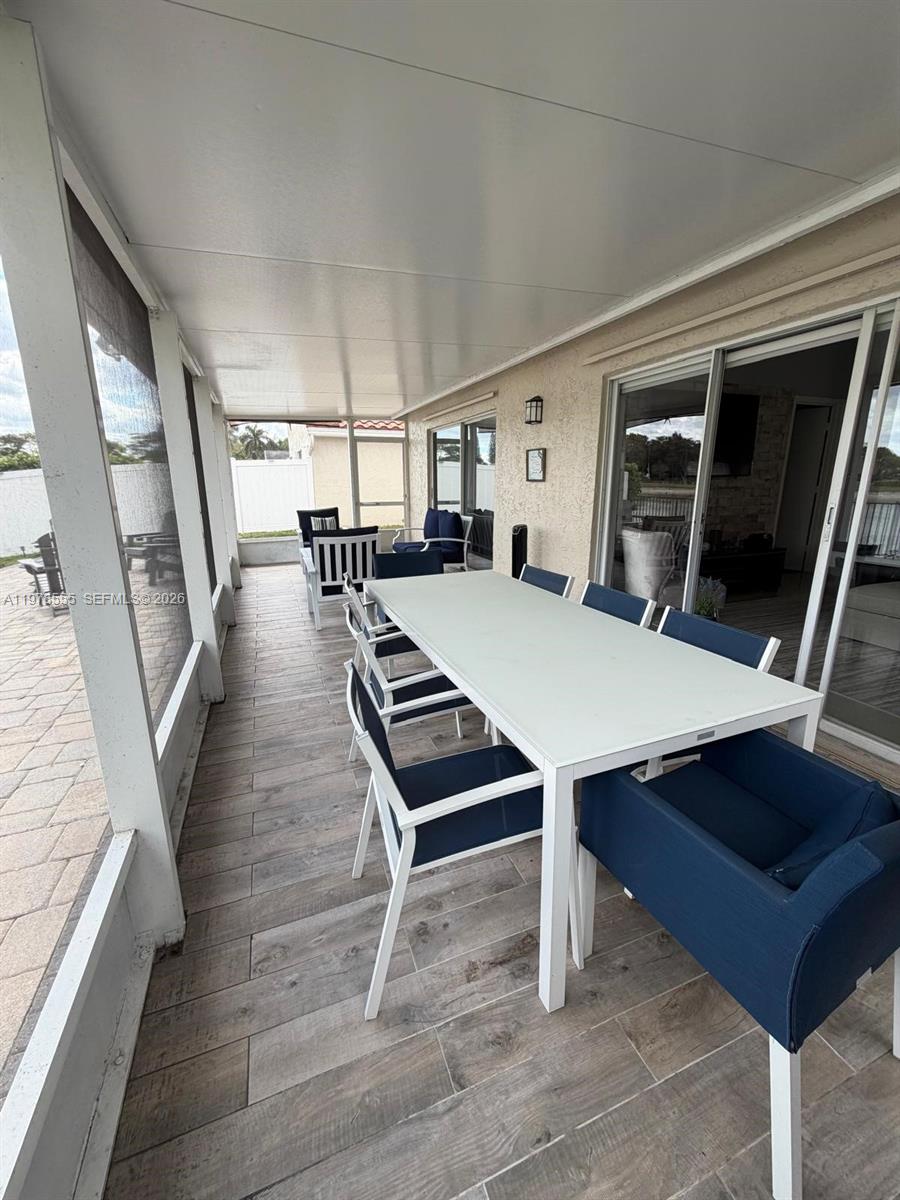 10285 Allegro Drive Boca Raton, FL 33428 - Photo 54 of 55 a room with lots of furniture and wooden floors