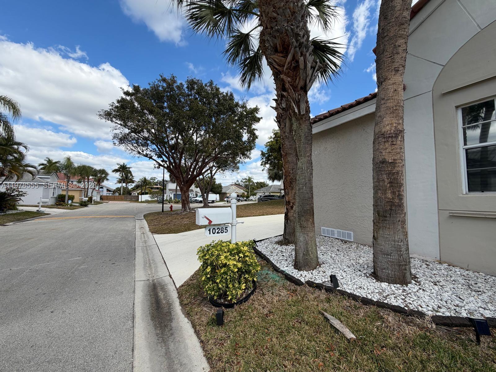 10285 Allegro Drive Boca Raton, FL 33428 - Photo 6 of 55 a view of a street with palm trees