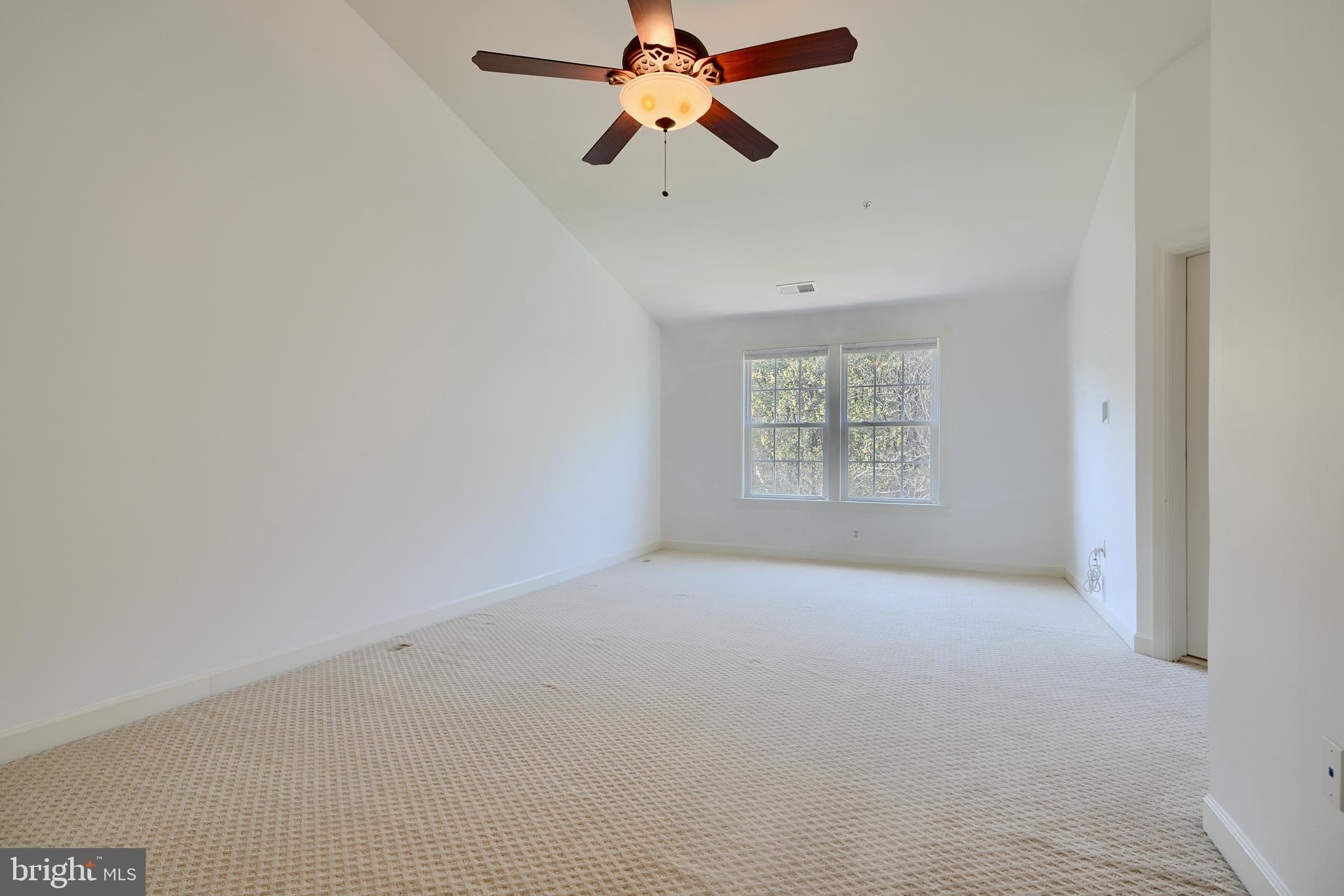 7570 Maidenhead Drive Hanover, MD 21076 - Photo 13 of 37 an empty room with windows and fan