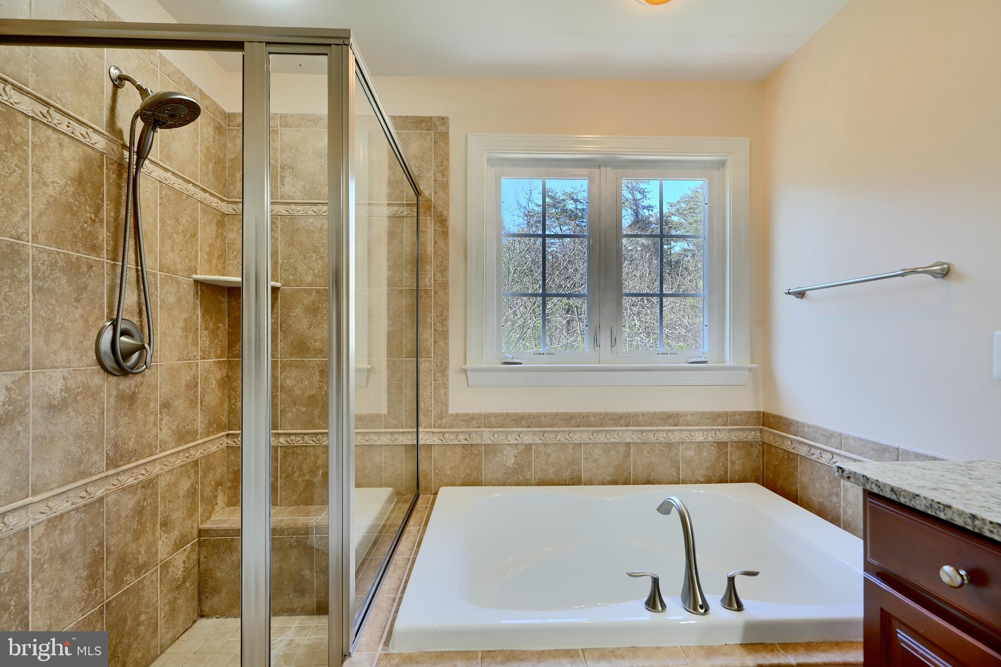 7570 Maidenhead Drive Hanover, MD 21076 - Photo 17 of 37 a bathroom with a tub and shower