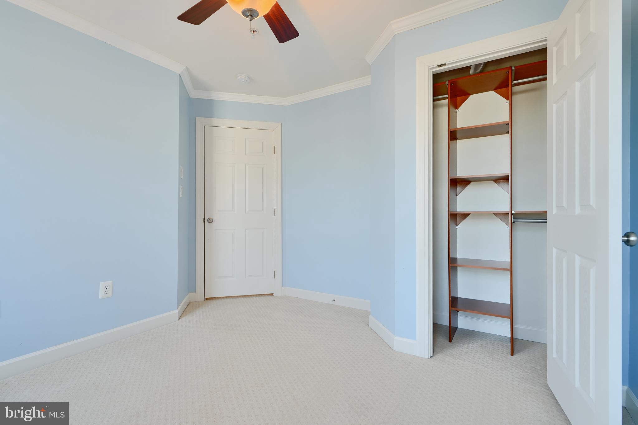 7570 Maidenhead Drive Hanover, MD 21076 - Photo 21 of 37 an empty room with closet and a ceiling fan