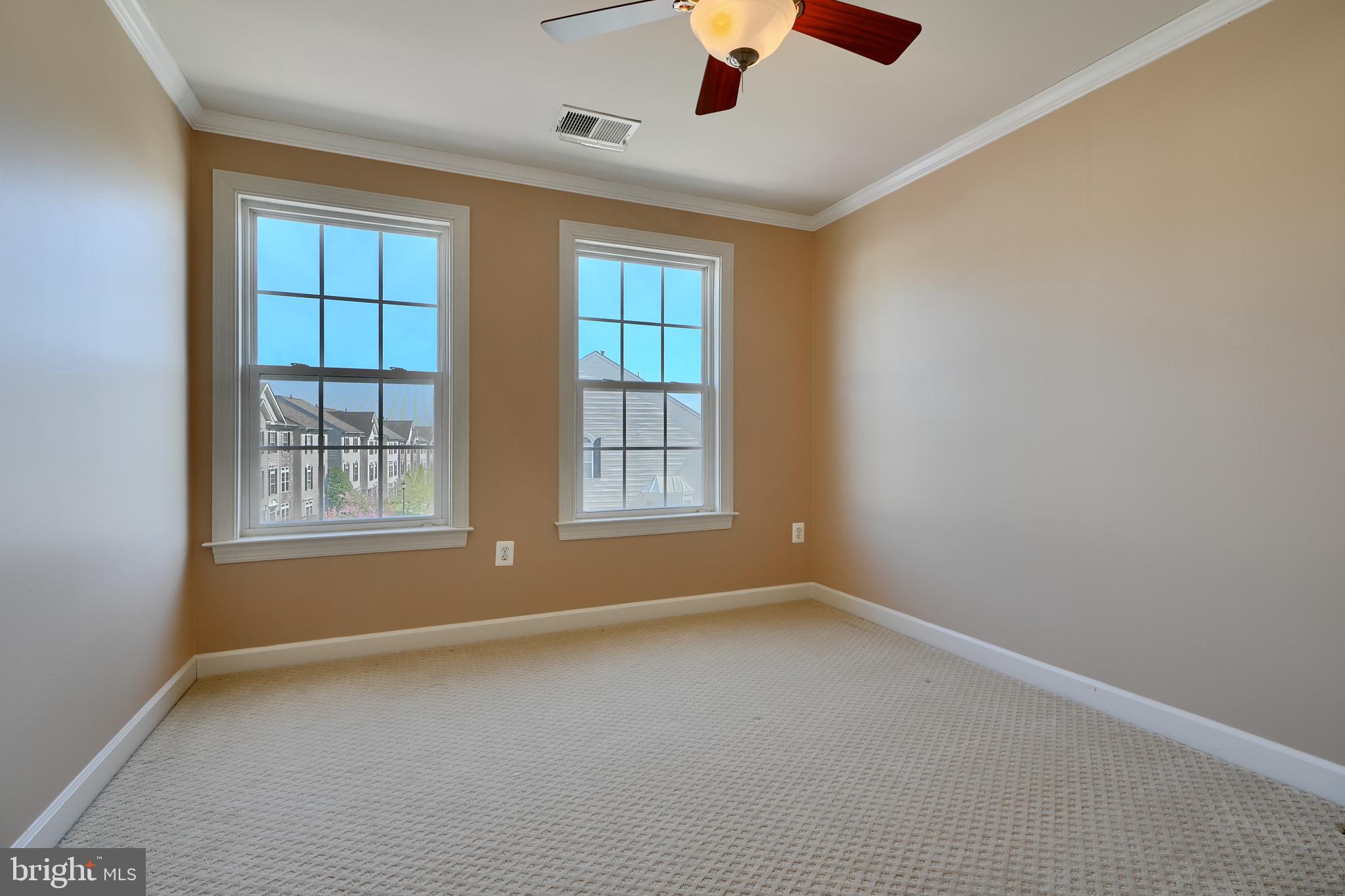 7570 Maidenhead Drive Hanover, MD 21076 - Photo 22 of 37 an empty room with chandelier fan and windows