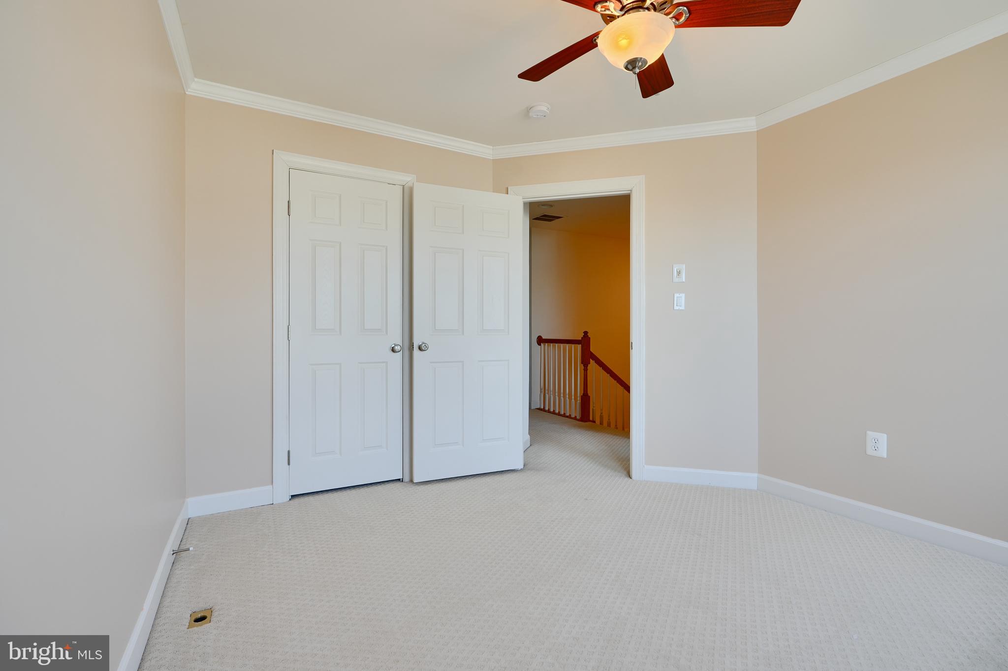7570 Maidenhead Drive Hanover, MD 21076 - Photo 23 of 37 an empty room with a ceiling fan and carpet