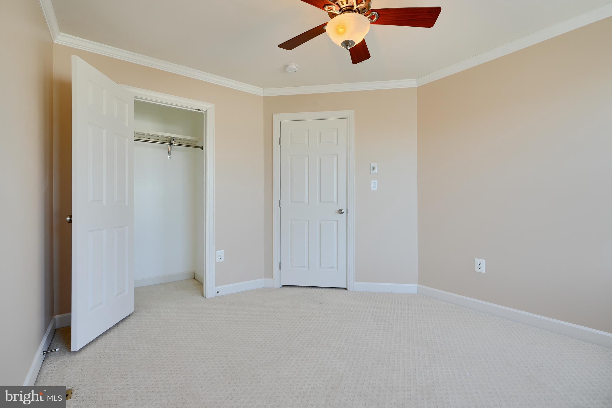 7570 Maidenhead Drive Hanover, MD 21076 - Photo 24 of 37 an empty room with a ceiling fan and a window