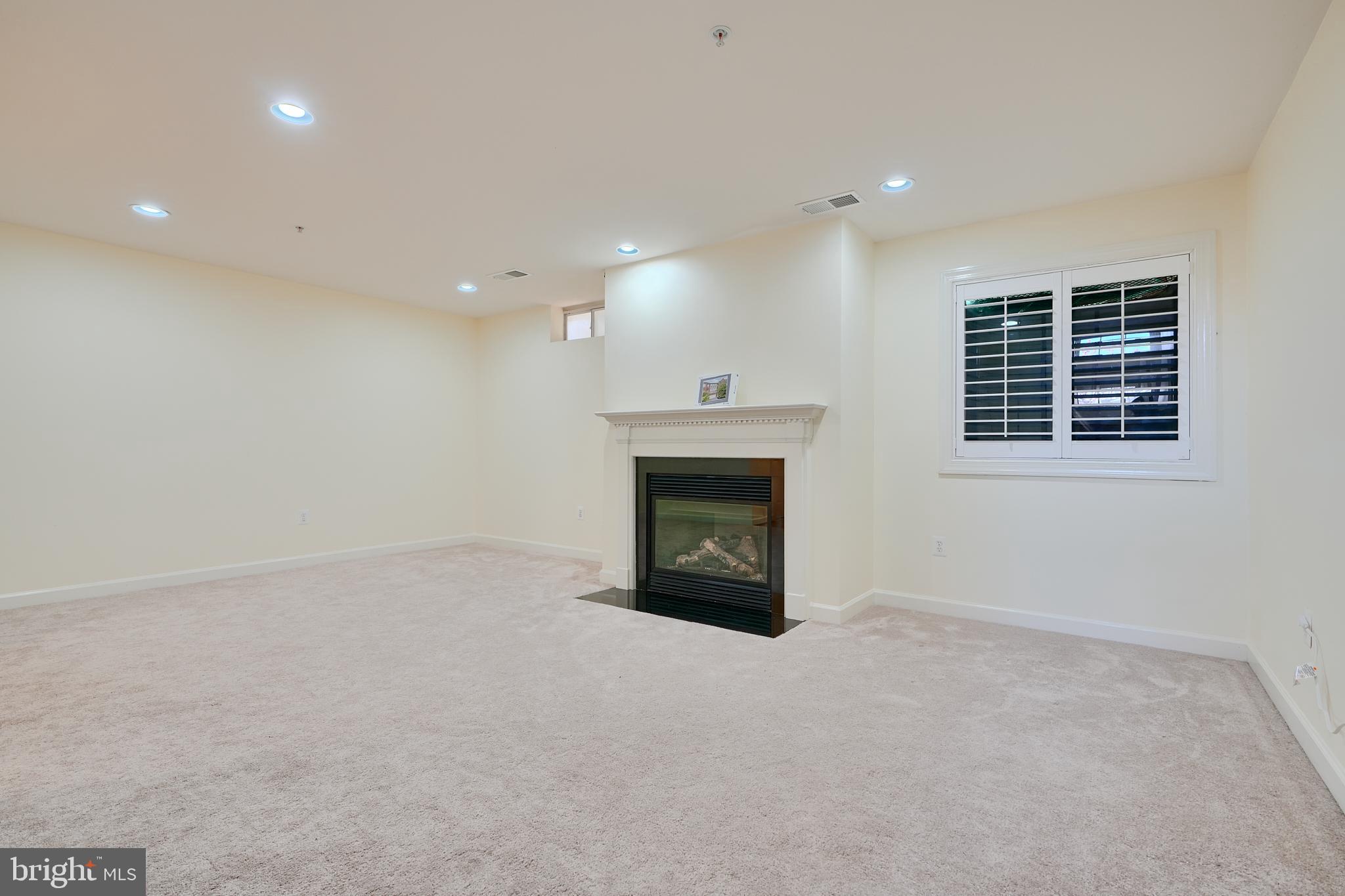 7570 Maidenhead Drive Hanover, MD 21076 - Photo 29 of 37 an empty room with a fireplace and window