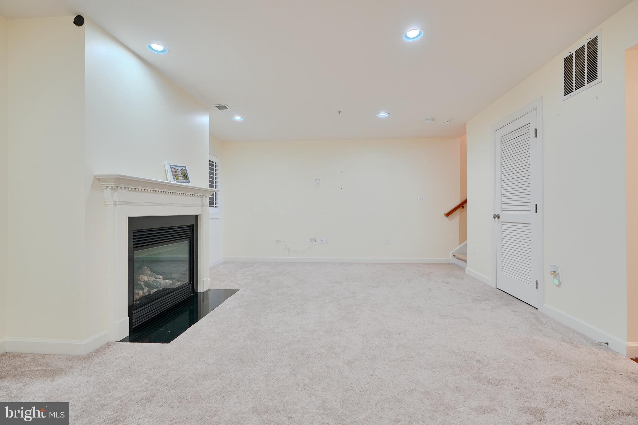 7570 Maidenhead Drive Hanover, MD 21076 - Photo 30 of 37 a view of an empty room with a fireplace