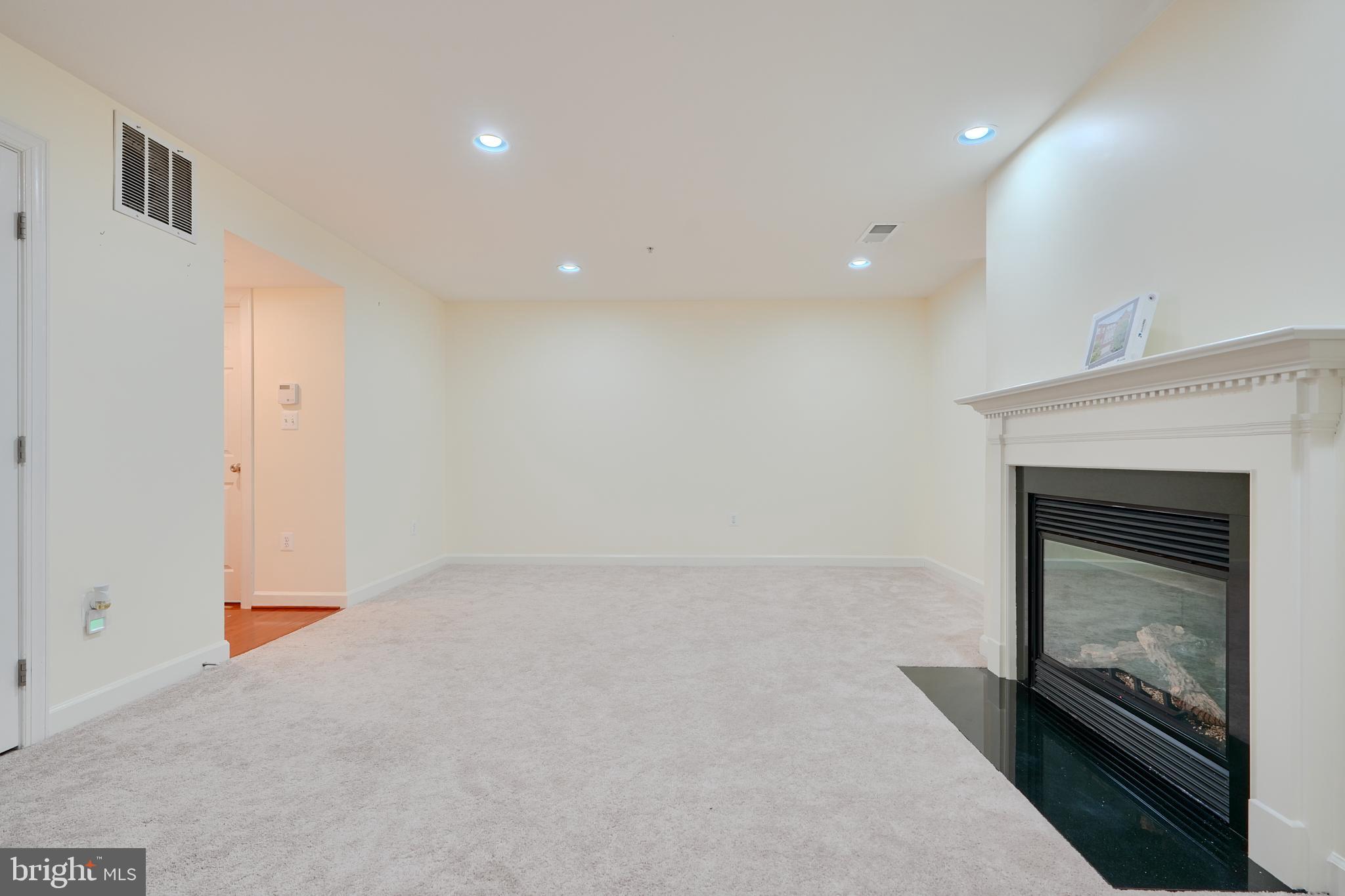 7570 Maidenhead Drive Hanover, MD 21076 - Photo 31 of 37 an empty room with a fireplace and window