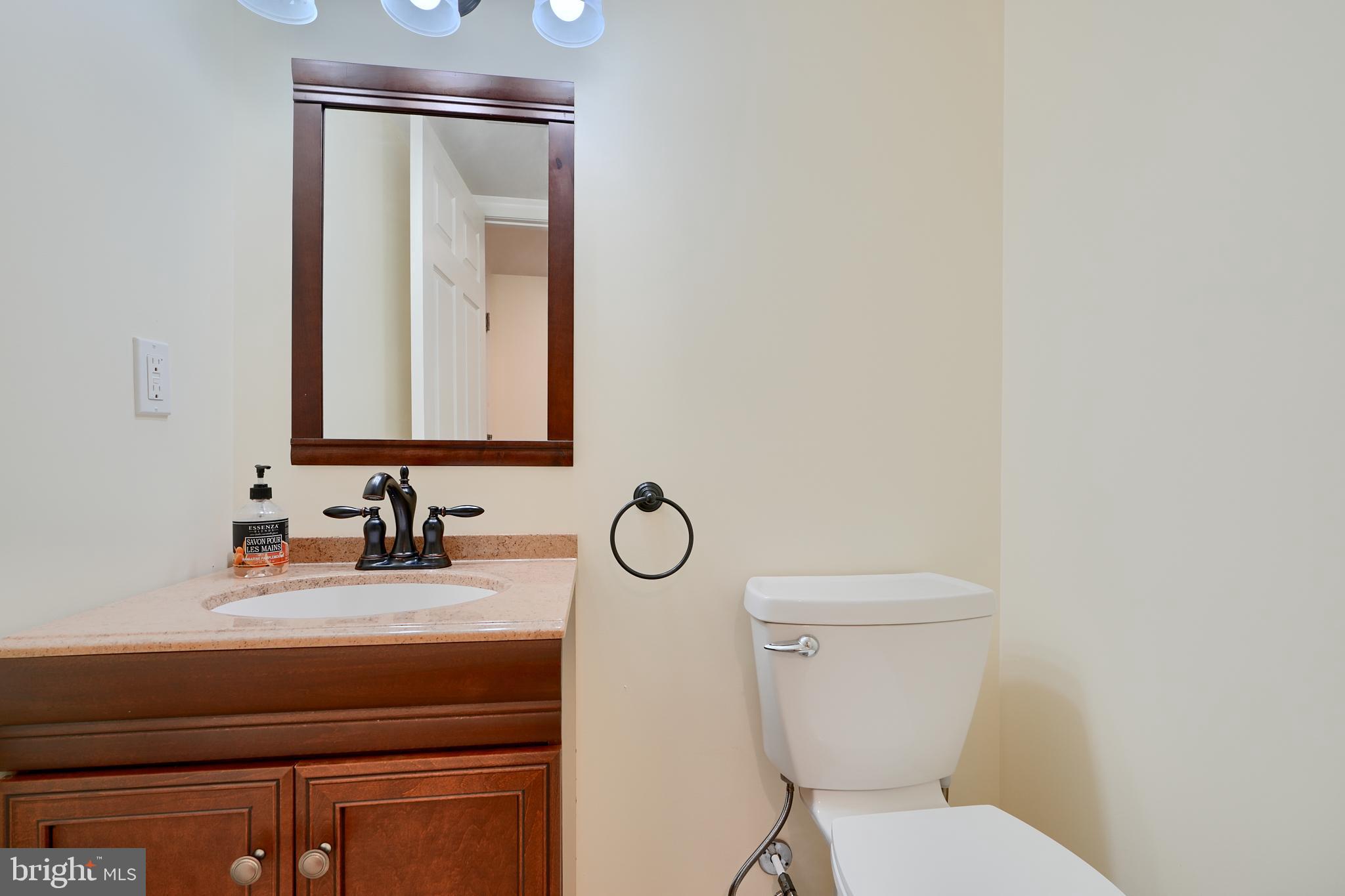7570 Maidenhead Drive Hanover, MD 21076 - Photo 33 of 37 a bathroom with a toilet sink and mirror