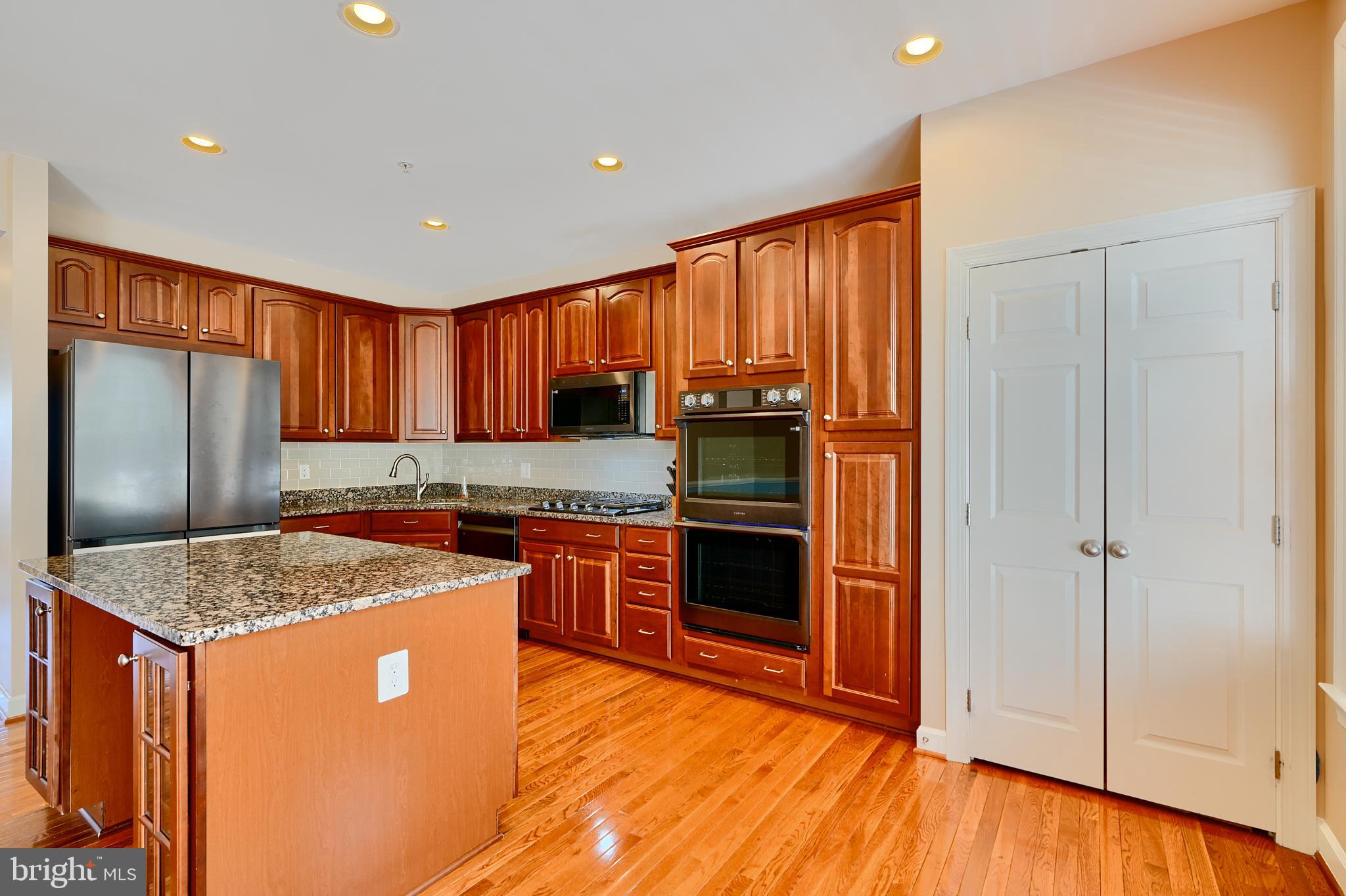 7570 Maidenhead Drive Hanover, MD 21076 - Photo 4 of 37 a kitchen with stainless steel appliances granite countertop refrigerator sink and stove