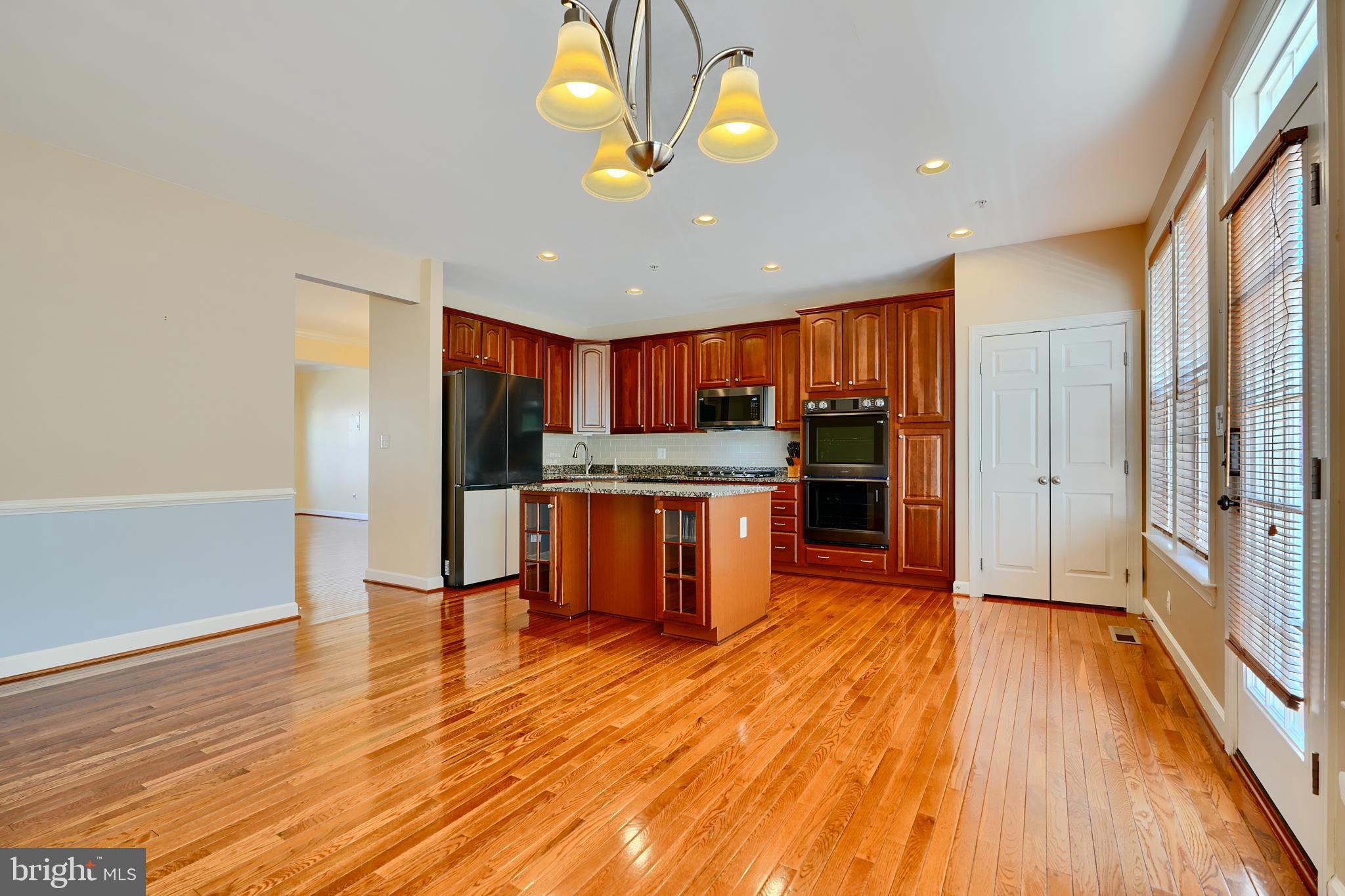 7570 Maidenhead Drive Hanover, MD 21076 - Photo 8 of 37 a kitchen with stainless steel appliances granite countertop a refrigerator and a stove top oven