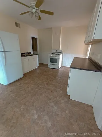 a view of a kitchen with microwave and cabinets