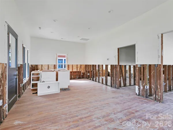 a view of a kitchen with furniture and wooden floor