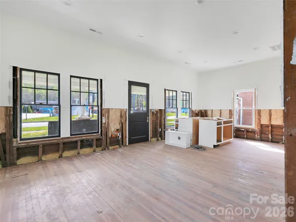a view of a bedroom with furniture and windows