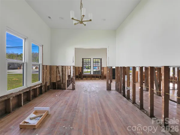 a view of a living room hardwood floor and a balcony
