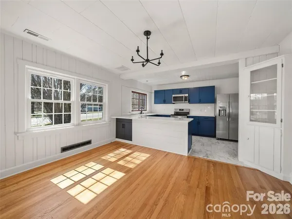 a view of kitchen with sink and wooden floor