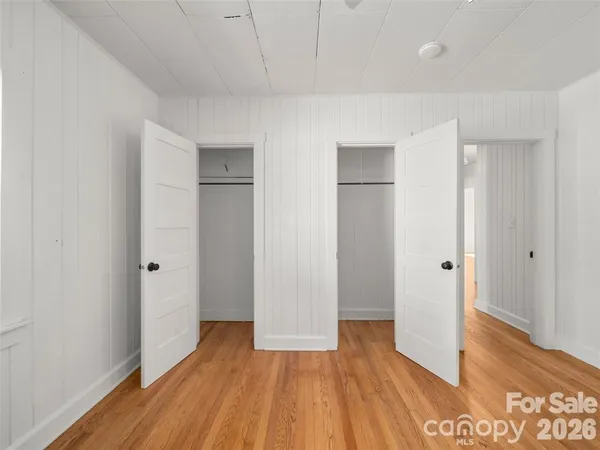 a view of hallway with wooden floor
