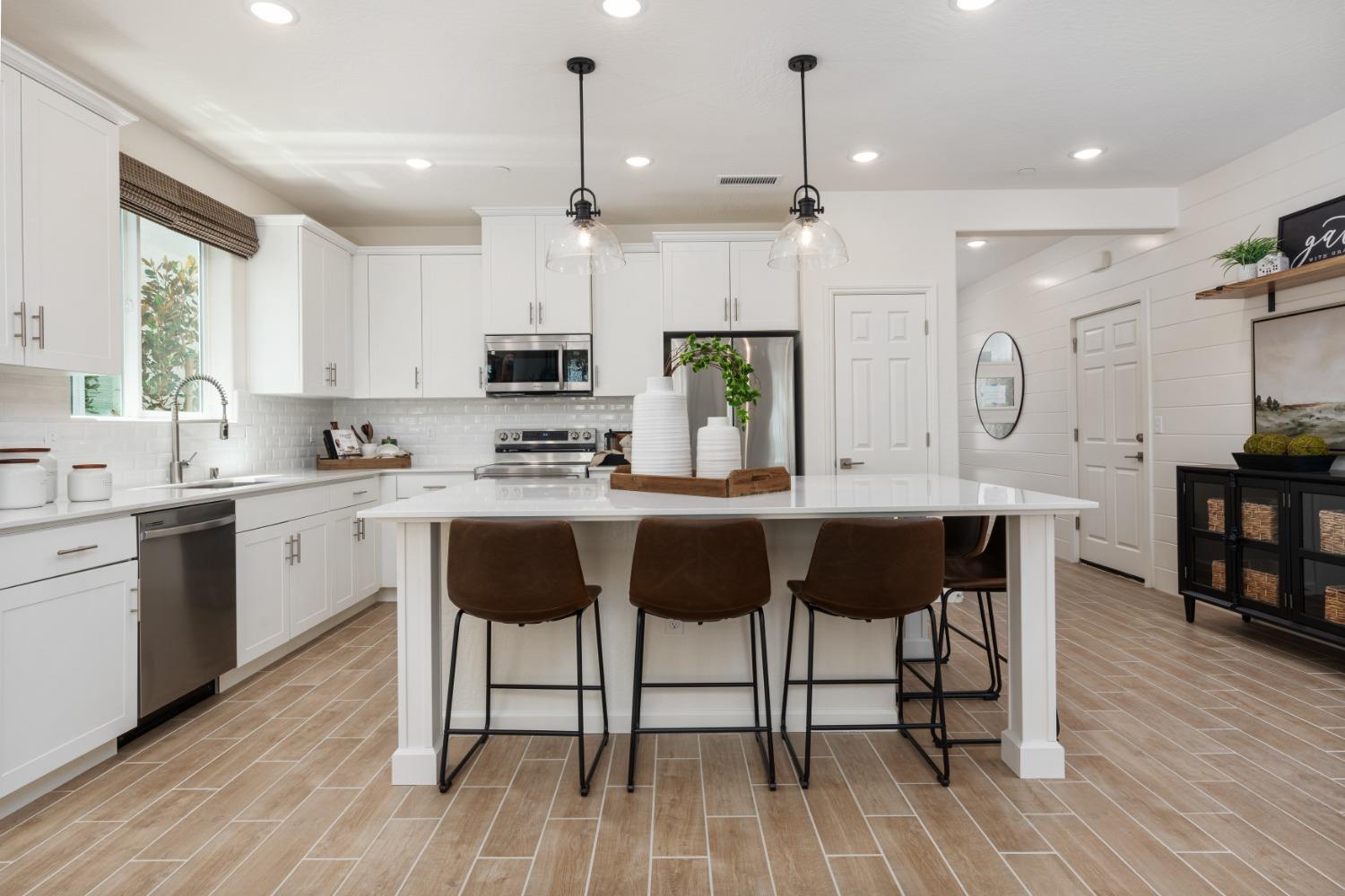 1609 Bloom Avenue Clovis, CA 93619 - Photo 9 of 23 a kitchen with a sink cabinets and wooden floor