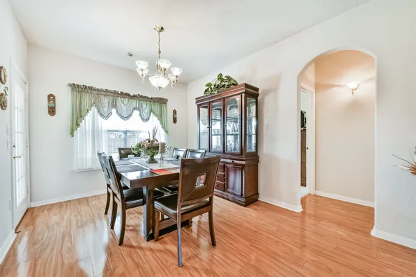 a view of a dining room with furniture and wooden floor