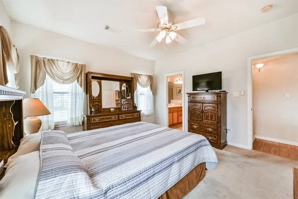 a bedroom with a bed and a chandelier