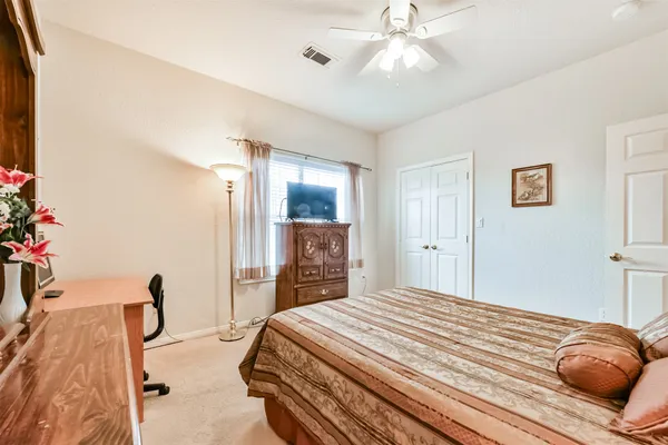 a bathroom with a granite countertop sink toilet a mirror and shower