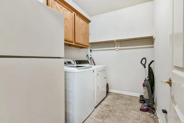 a bedroom with a bed a mirror on dresser and a window
