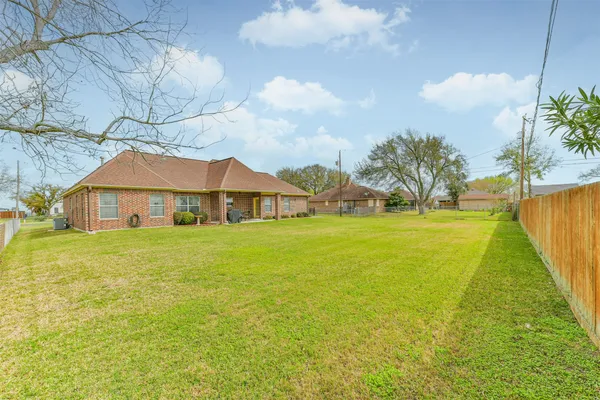 a front view of house with yard and swimming pool