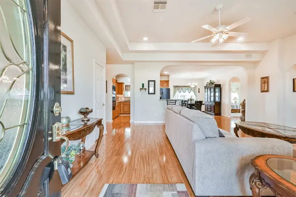 a living room with furniture and a chandelier