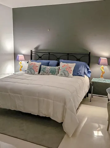 a bedroom with a bed and a lamp