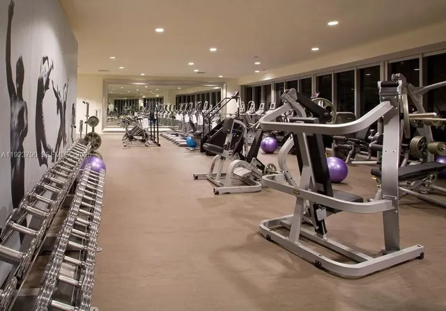 a view of a room with gym equipment and a large window