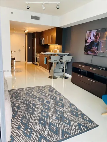 a living room with dining room and kitchen view