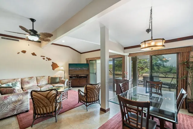 a living room with furniture a ceiling fan and a window