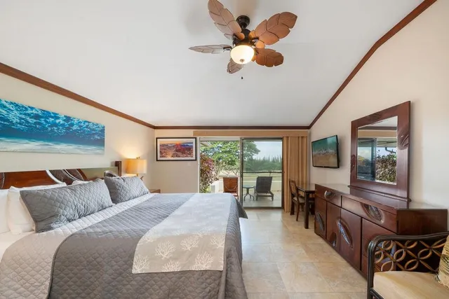 a bedroom with a large bed a chandelier and windows