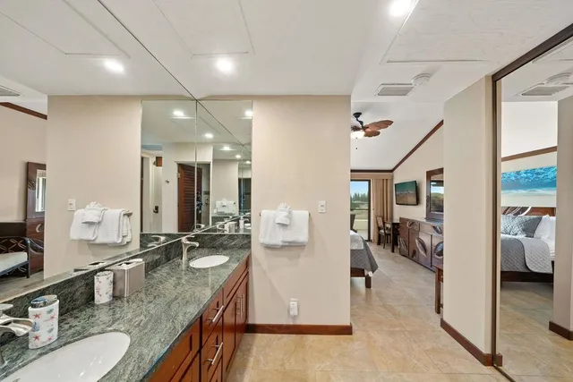a bathroom with sink shower and mirror