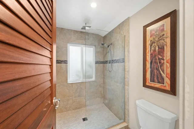 a bathroom with a shower toilet and sink